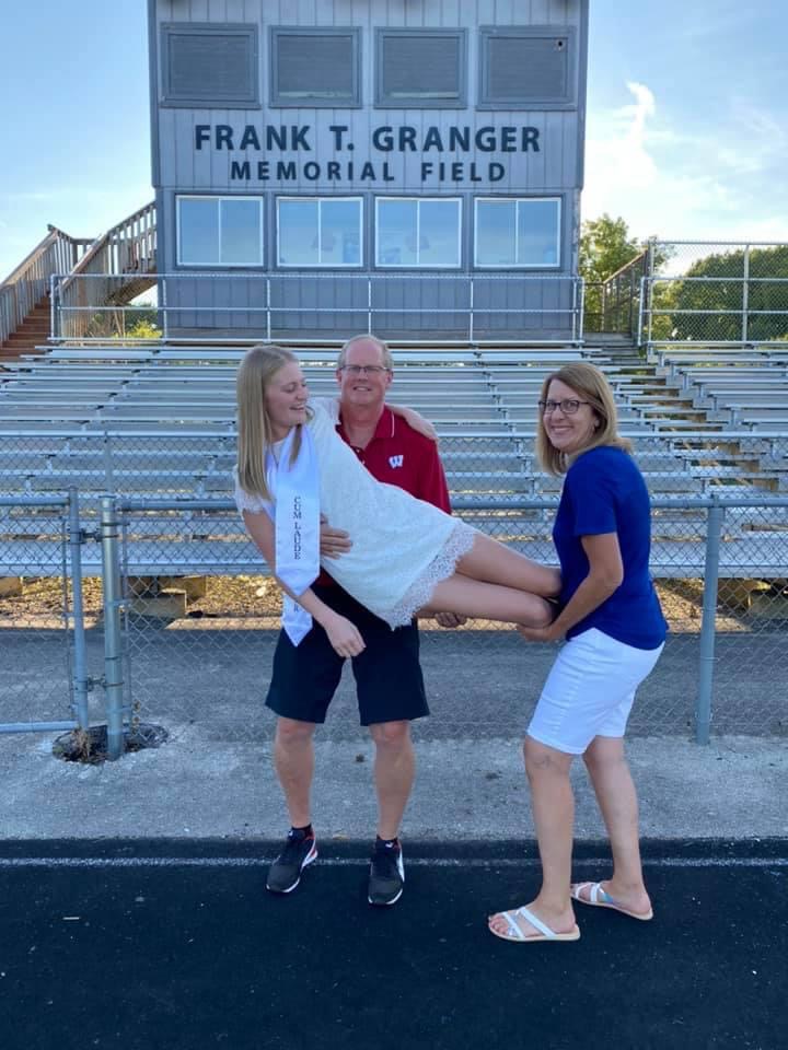 taylor and parents at high school graduation